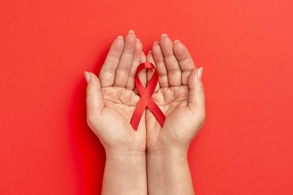 person holding an world aids day ribbon 1